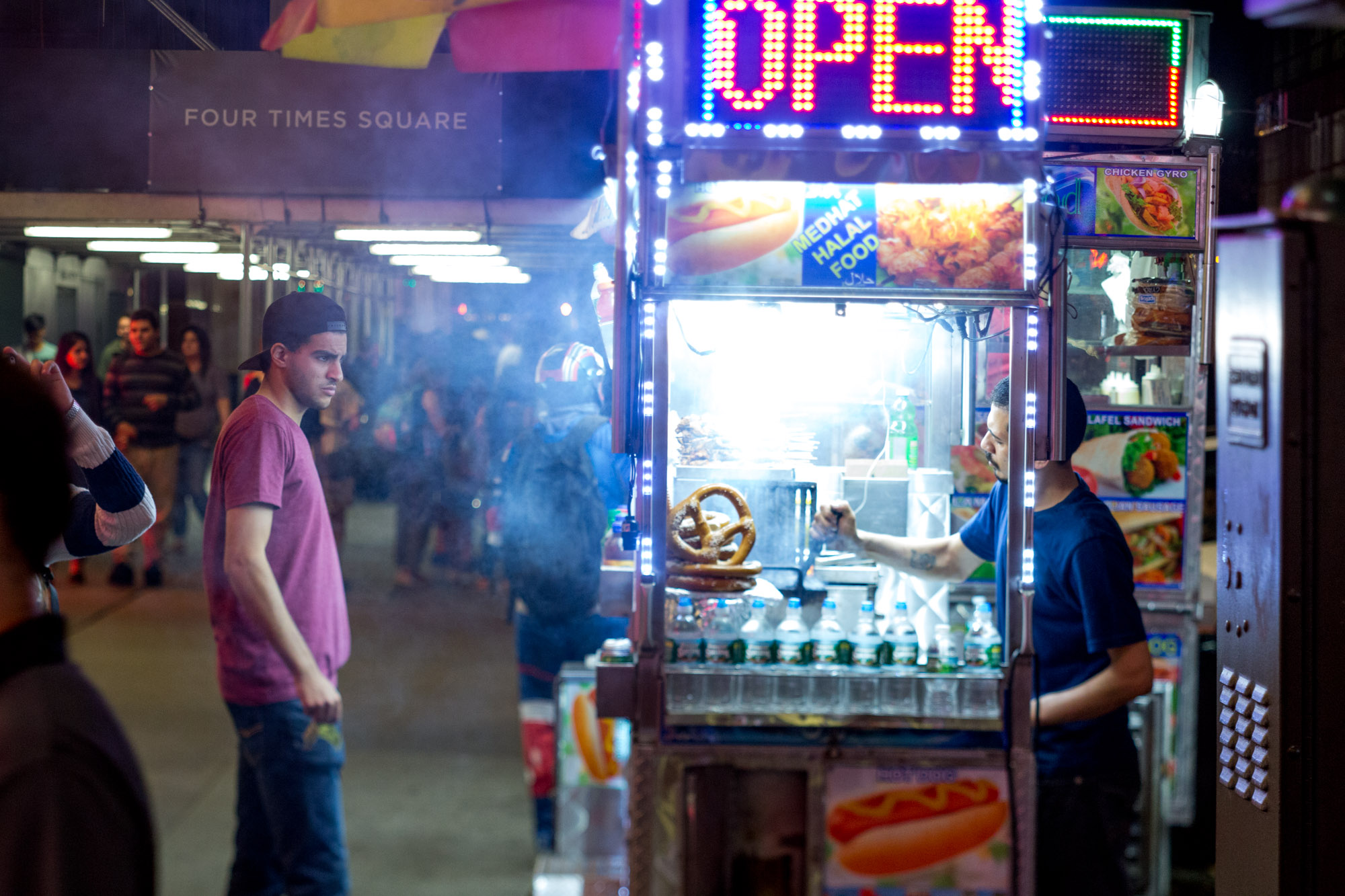 A man considers the menu at a food cart